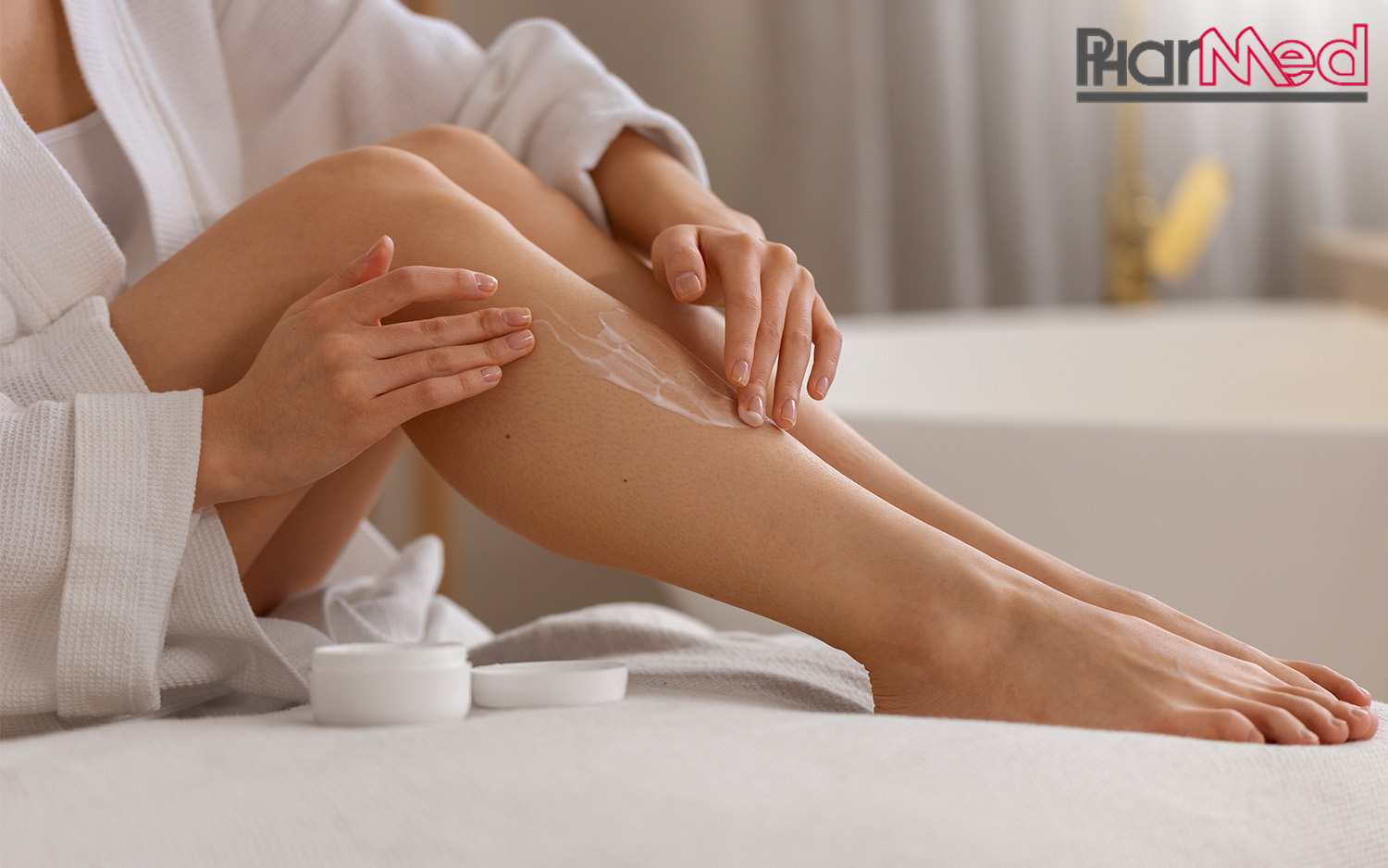 A lady with smooth skin applying lotion to her legs.