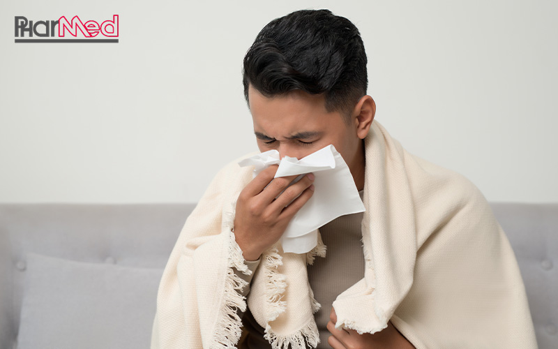 Man sneezing, a common symptom of mild conditions.